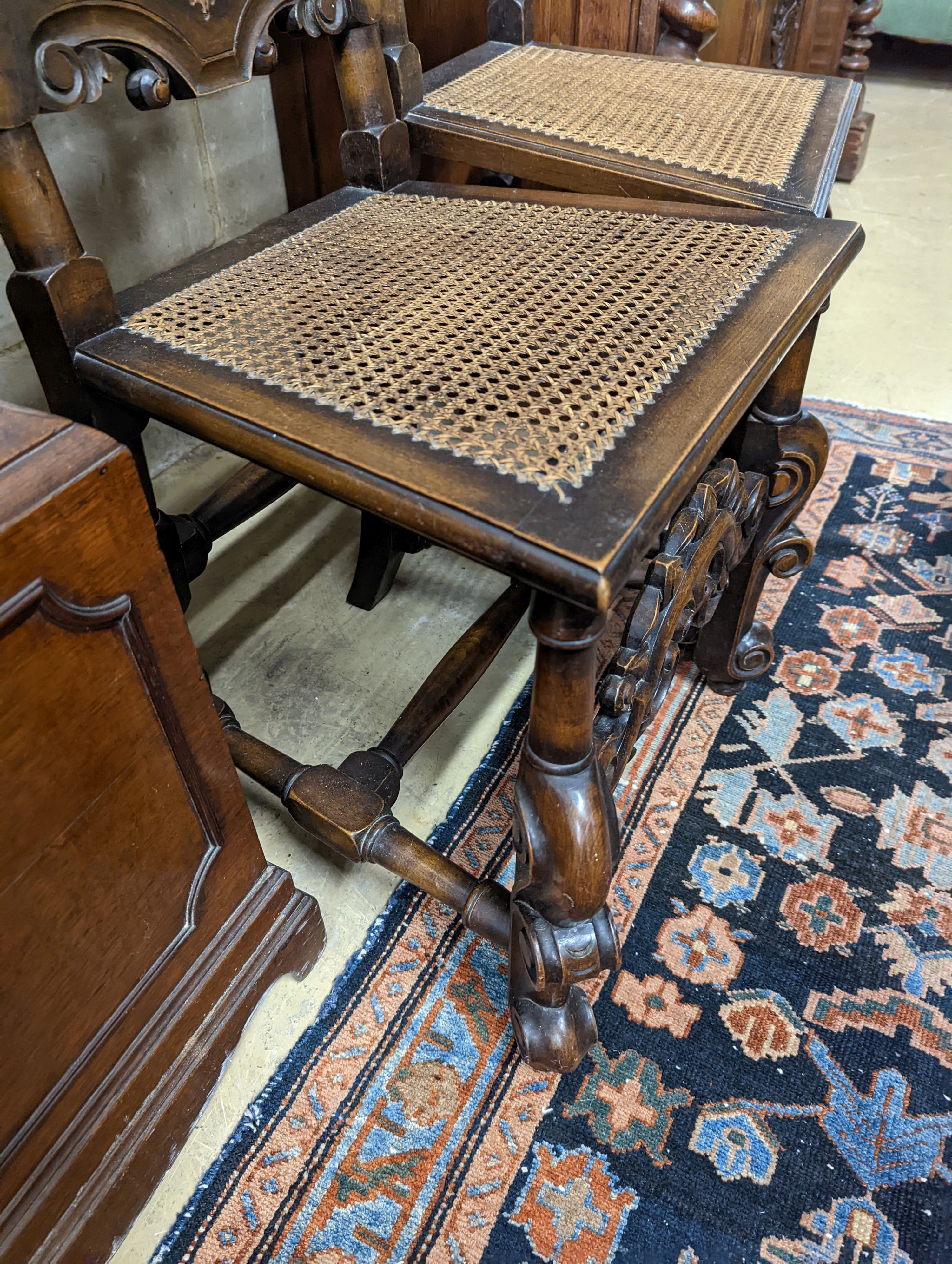 A pair of Carolean design carved beech high back chairs